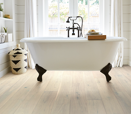 Bathroom with wood-look luxury vinyl flooring from Perge Carpet & Floors in Wheaton, MD