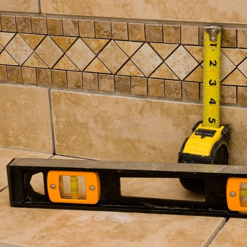 tape measure and spirit level against wall from Perge Carpet & Floors in Wheaton, MD | From facts to fashion, we make beautiful floors easy! Perge Carpet & Floors in Wheaton | Perge Carpet & Floors | Wheaton  |  301-942-3330